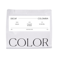 The Pull & Pour Shop Decaf Colombia Huila coffee bag with minimalist white packaging and black typography.
