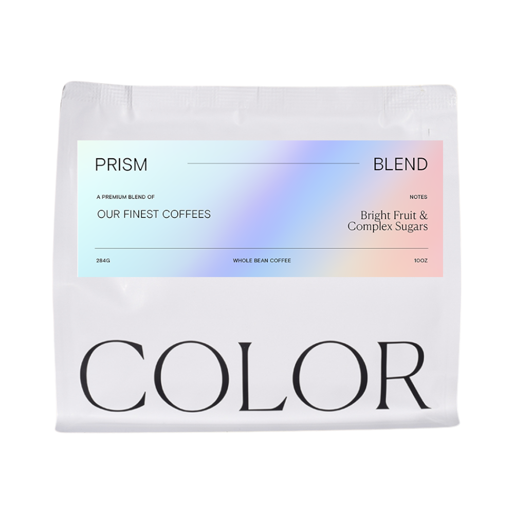 The Pull & Pour Shop Prism Blend whole bean coffee bag with a holographic label featuring fruit and sugar notes.