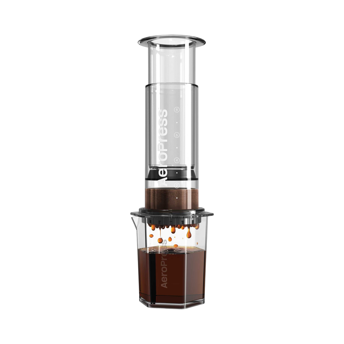 The Pull & Pour Shop AeroPress Clear XL coffee maker with a transparent Tritan chamber brewing coffee into a carafe.