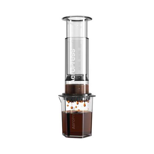 The Pull & Pour Shop AeroPress Clear XL coffee maker with a transparent Tritan chamber brewing coffee into a carafe.