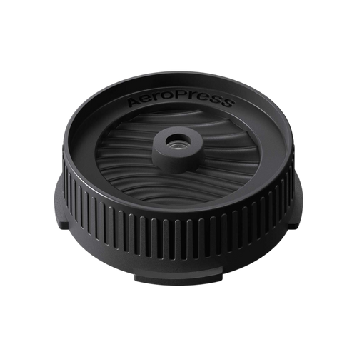 The Pull & Pour Shop AeroPress Flow Control Filter Cap in black plastic with a pressure-actuated valve design.