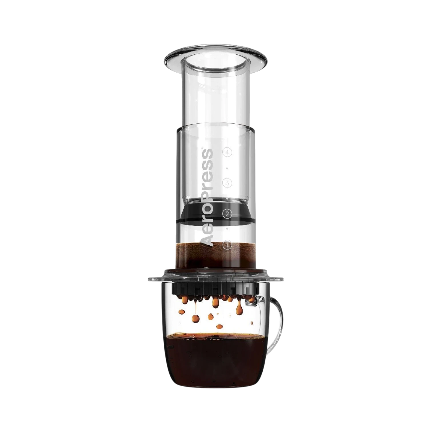 The Pull & Pour Shop AeroPress Clear coffee maker in transparent Tritan plastic brewing coffee into a glass mug.