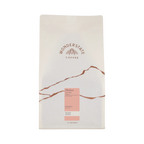 The Pull & Pour Shop Ethiopia Okoluu coffee bag featuring a minimalist white design with mountain-inspired graphics.