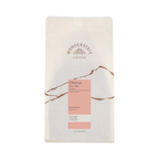 The Pull & Pour Shop Ethiopia Okoluu coffee bag featuring a minimalist cream design with pink label and floral notes.