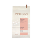 The Pull & Pour Shop Ethiopia Okoluu coffee bag featuring a light cream paper design with a soft pink label.