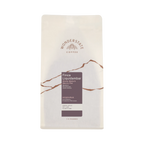 The Pull & Pour Shop Honduras Finca Liquidambar coffee bag with white packaging and brown mountain graphic design.