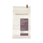 The Pull & Pour Shop Honduras Finca Liquidambar coffee bag with white paper and purple label detailing origin notes.