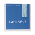 The Pull & Pour Shop Little Wolf Companion Blend instant coffee box with blue packaging and six single-serve packets.