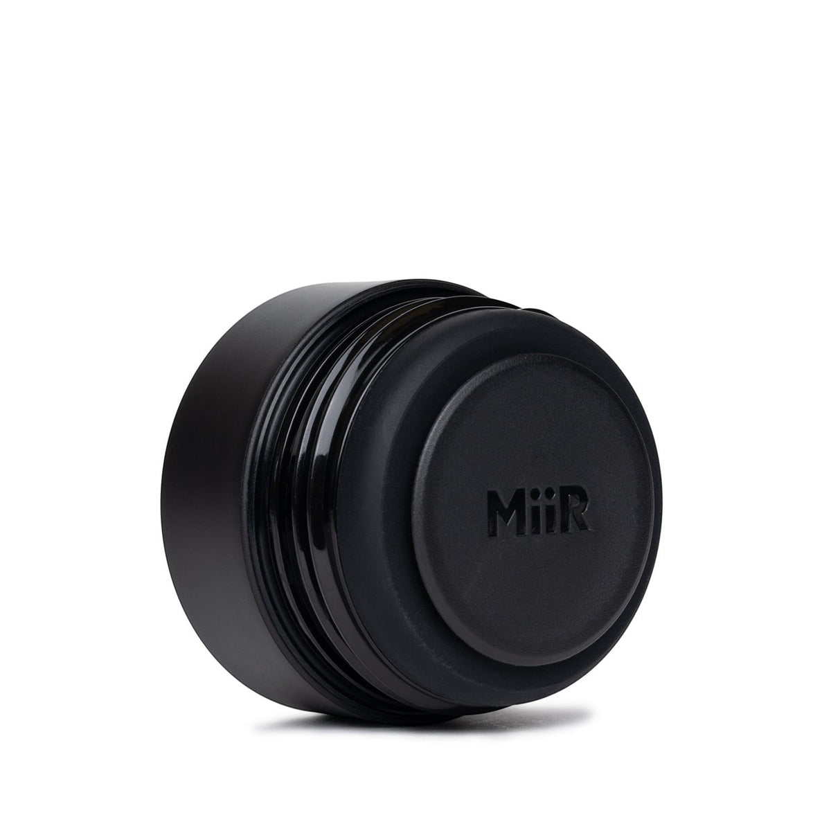 The Pull & Pour Shop MiiR 360 Traveler black leakproof lid with center push-button for easy 360-degree sipping.