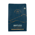 The Pull & Pour Shop Wonderstate Coffee Organic Driftless medium dark roast blend in a blue bag with gold mountain art