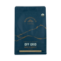 The Pull & Pour Shop Wonderstate Organic Off Grid super dark roast coffee bag in deep blue with gold mountain art